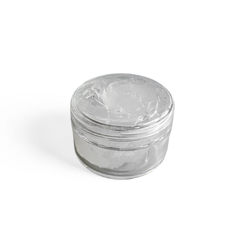 Clear glass jar filled with 100% food grade silicone grease with a lid on a white background