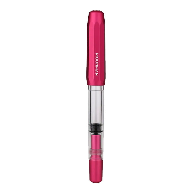Moonman T1 (Pink) - Fine fountain pen with pink anodized cap, clear barrel, piston filler, and steel fine nib, showcasing ink level visibility.