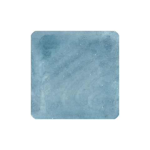 Tono & Lims Taurus (Shimmer) fountain pen ink swatch showing a muted blue watercolor-style wash with subtle shimmer speckles, 30ml bottle.