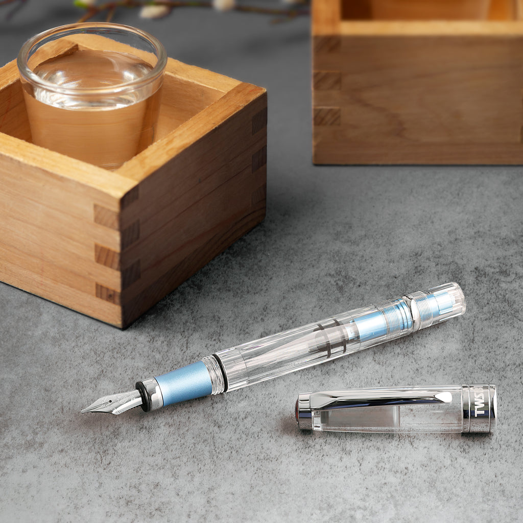 TWSBI Diamond 580 ALR (Iceberg) fountain pen with extra fine nib, featuring a clear body, light blue grip, and piston ink-filling system, displayed without its cap.