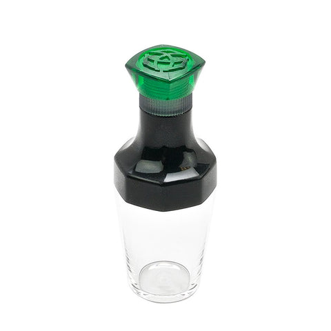 VAC20A Ink Bottle - Green: Clear storage jar with a two-piece grinder lid, designed for TWSBI pen refills, featuring green top and black middle section.