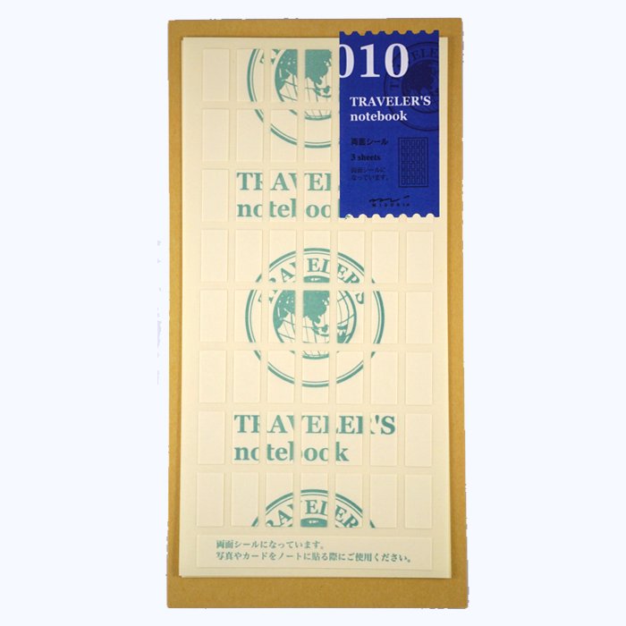 Traveler's Company #010 Double-Sided Stickers, featuring three sheets with 56 adhesive pieces each, designed for securing photos or memorabilia in notebooks.