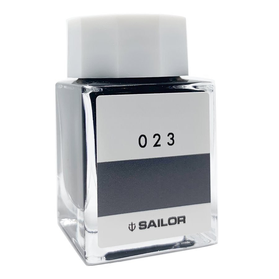 Square glass bottle of Sailor Ink Studio #023, featuring a white cap and label with the number 023 over a dark swatch, holding 20ml of dye-based ink.