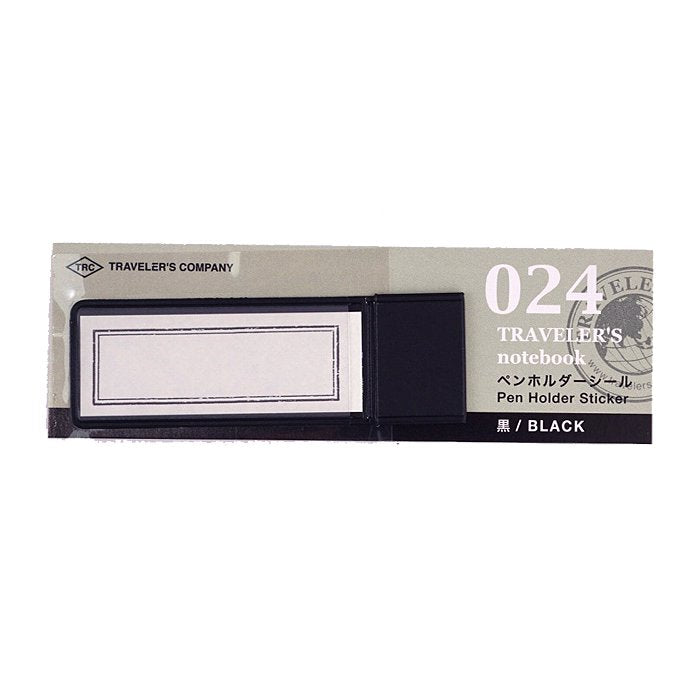 Traveler’s Company Pen Holder - Black, includes adhesive pen-holder band, matching label stickers, and backing card with product details, designed for notebook attachment.