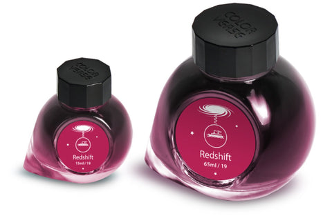 Two glass bottles of Redshift ink, 65ml and 15ml, with galaxy-themed labels, part of Colorverse's Astrophysics Collection, offering plant-based, dye-based fountain-pen ink.