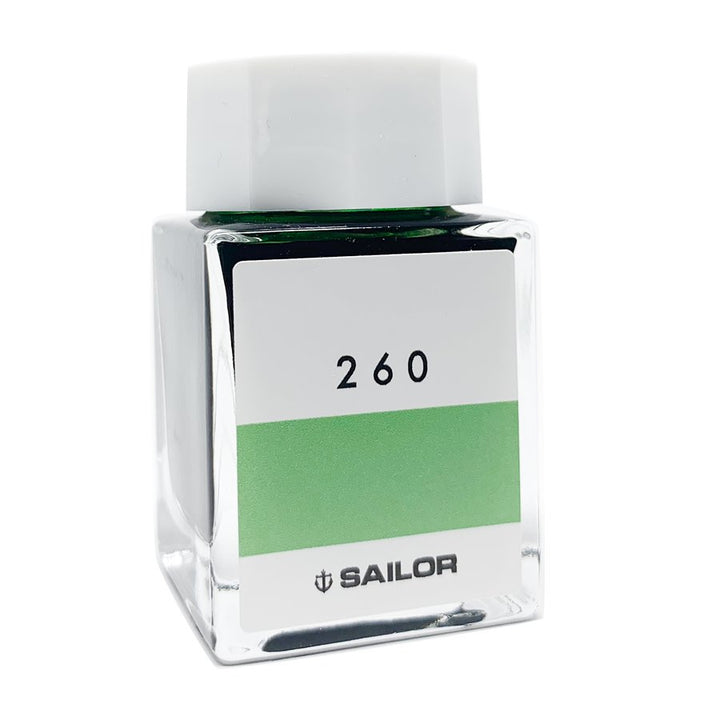 Square glass bottle with white cap, green ink visible inside, labeled Sailor Ink Studio #260 - 2ml, part of a curated 100-color collection.