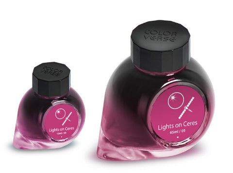 Lights On Ceres - 65ml + 15ml Set includes two snail-shell–shaped ink bottles with black caps, featuring a stylized planet label.