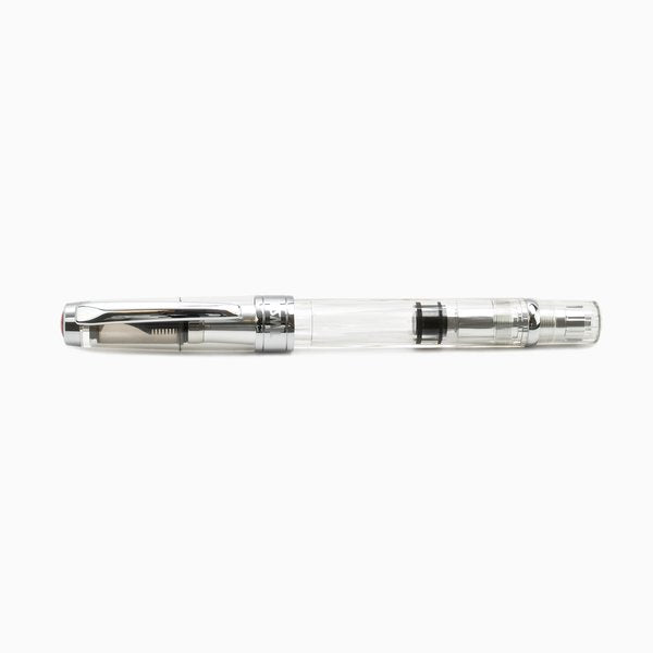 Diamond 580AL (Silver) - Extra Fine fountain pen, transparent body with silver trim, showcasing piston-filling mechanism and detachable components, clear cap posted on back.
