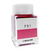 Square glass bottle of Sailor Ink Studio #731, 2ml, with white cap, containing pink/red dye-based fountain-pen ink.