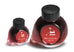 Two glass bottles of Colorverse ink, Mars Curiosity set, featuring dark red ink, black caps, and a Mars rover icon on red labels.