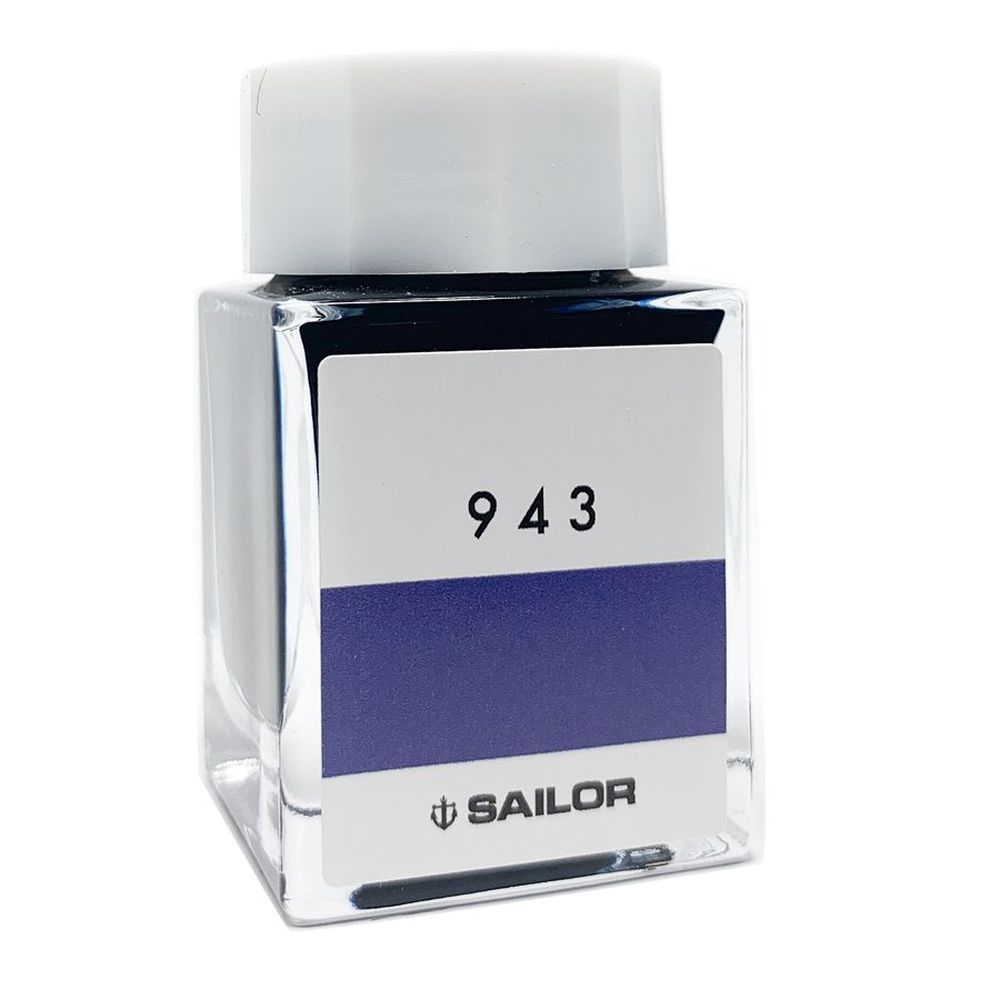Square glass bottle of Sailor Ink Studio #943, featuring a white label, deep bluish-purple band, and white screw cap, containing 20ml of dye-based ink.