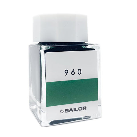 Sailor Ink Studio #960 - 20ml: A square glass bottle with a white cap, showcasing a green-tinted fountain-pen ink. Compact and sleek design.