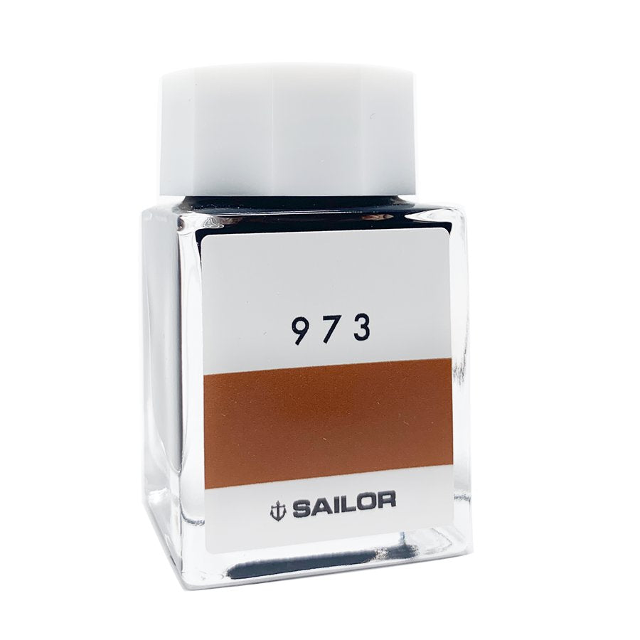Sailor Ink Studio #973 - 20ml: Square glass bottle with a white cap, displaying a swatch of brown-orange ink.