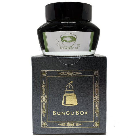 Bungubox 88 - 50ml fountain-pen ink bottle with a black cap and white label, sits atop its matte black branded box with gold accents.