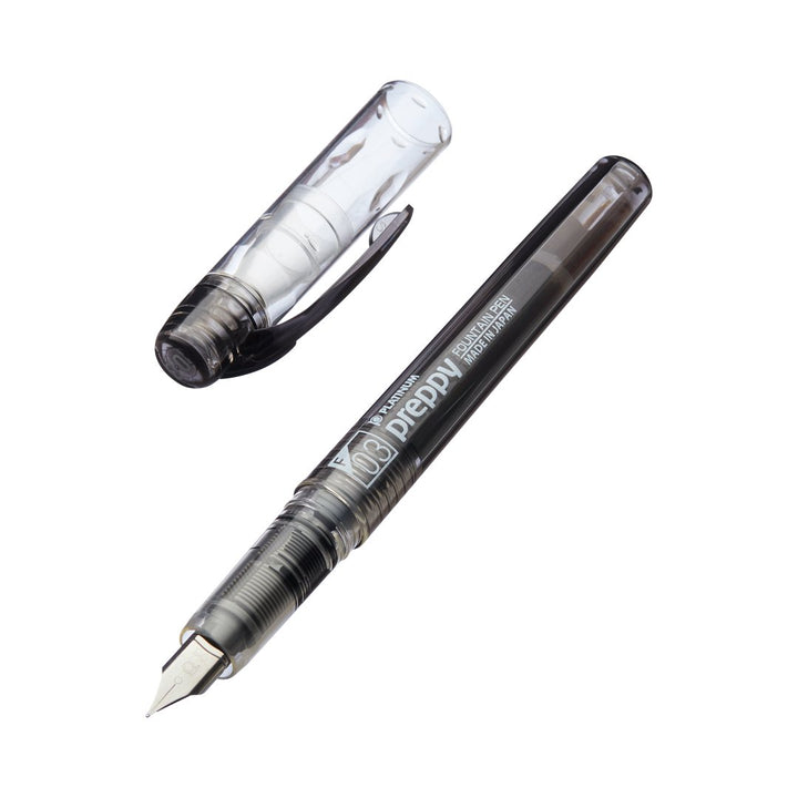 Platinum Preppy - Fine (Black) clear-barrel fountain pen, uncapped, showcasing its sleek design and fine nib, known for its reliable performance and slip & seal mechanism.