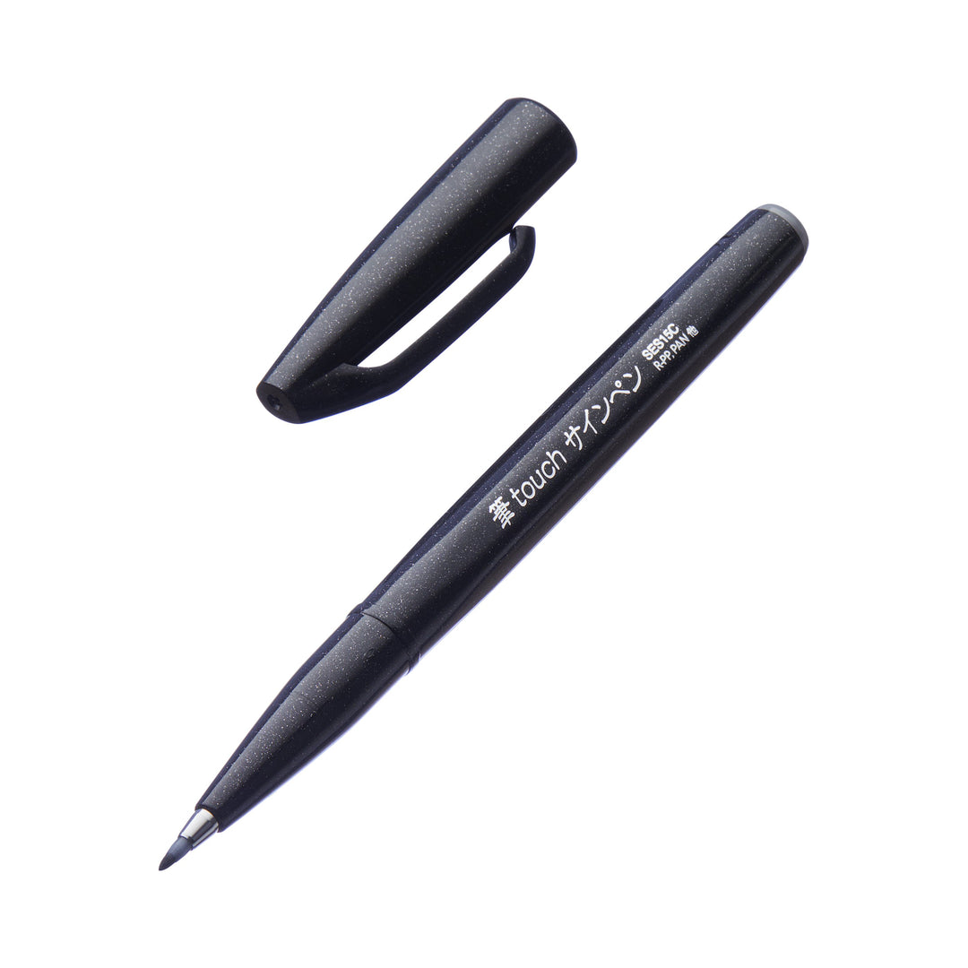 Fude Touch Brush Sign Pen - Black with a felt brush tip, cap removed, on a white background, ideal for graphic work and illustrations.