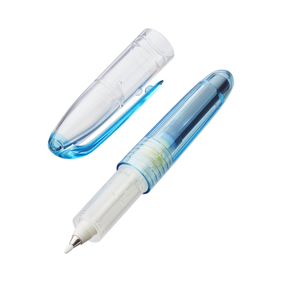Petit2 Mini Sign Pen - Medium (Light Blue) shown with transparent barrel, visible ink reservoir, metal tip, and matching clear cap with clip laid beside it.