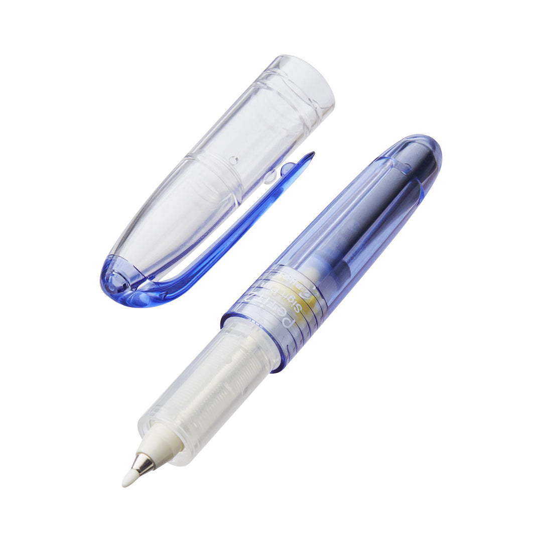 Petit2 Mini Sign Pen - Medium - Set of 8, showcasing a translucent blue correction-tape dispenser with an exposed tape-feed and cap beside it.