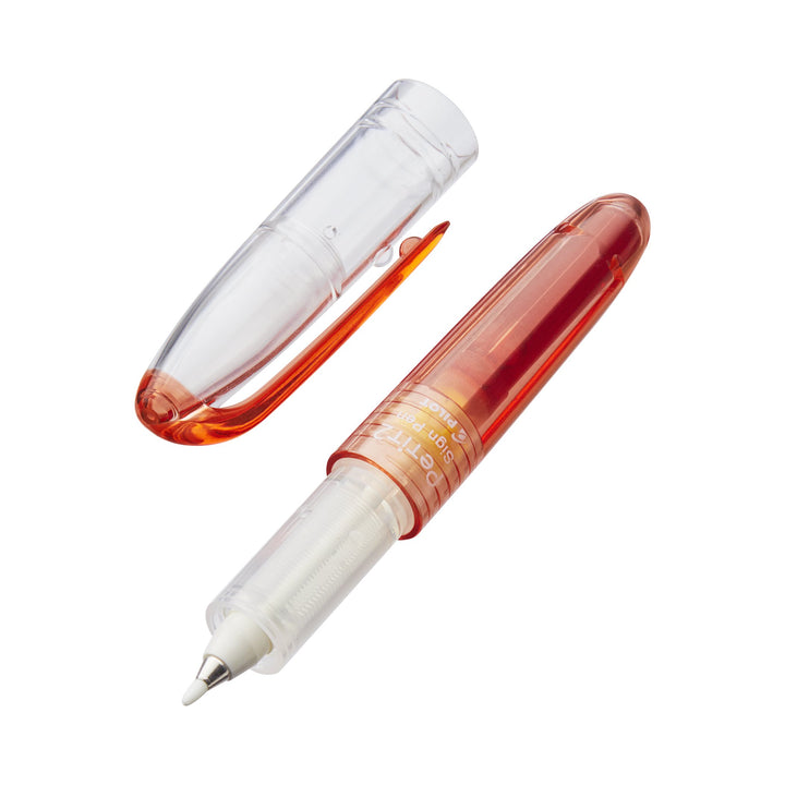 Petit2 Mini Sign Pen - Medium (Red) shown uncapped, revealing its white nib and translucent-orange plastic body with built-in ink reservoir, highlighting its portable design.