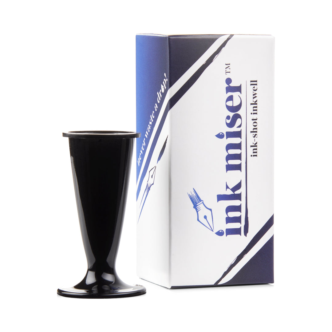 Ink Shot Inkwell - Black, a compact, goblet-shaped ink cup with branded packaging, designed for efficient fountain pen ink use and conservation.