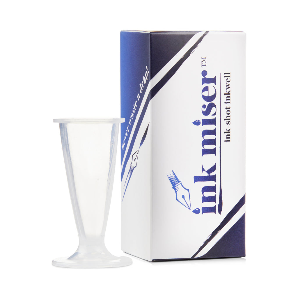Ink Shot Inkwell - Clear: A small, funnel-shaped plastic inkwell beside its labeled box, designed for efficient fountain-pen ink use and easy refilling.