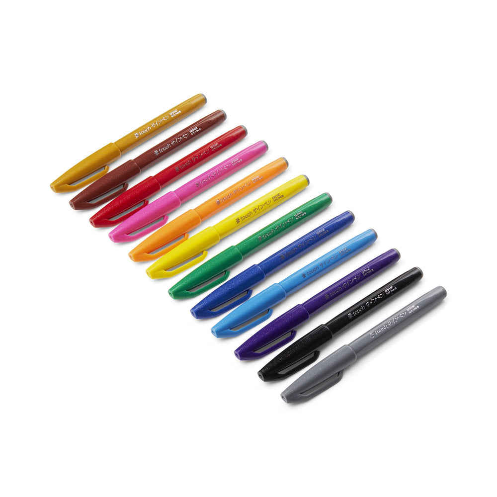 Fude Touch Brush Sign Pen - Brown lined up among colorful pens, featuring a felt brush tip, ideal for illustrations and scrapbooking. Made of 81% recycled material.