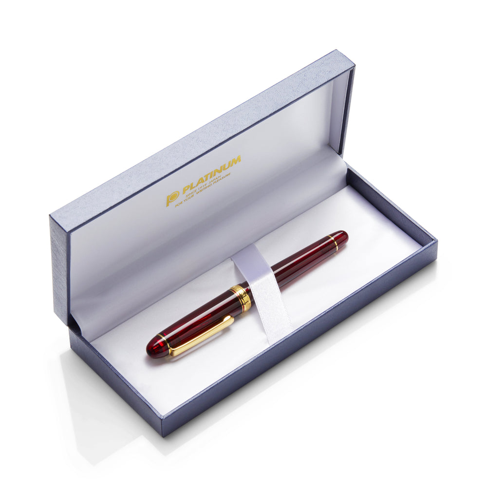 Platinum #3776 Century Bourgogne fountain pen set in a satin-lined box, featuring a glossy burgundy pen with gold trim and a 14k gold nib.