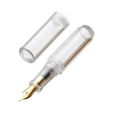 Wancai Mini (Clear) - Fine fountain pen disassembled, showing transparent cap, clear barrel with nib housing, and gold-plated nib. Demonstrates assembly of compact, versatile pen.