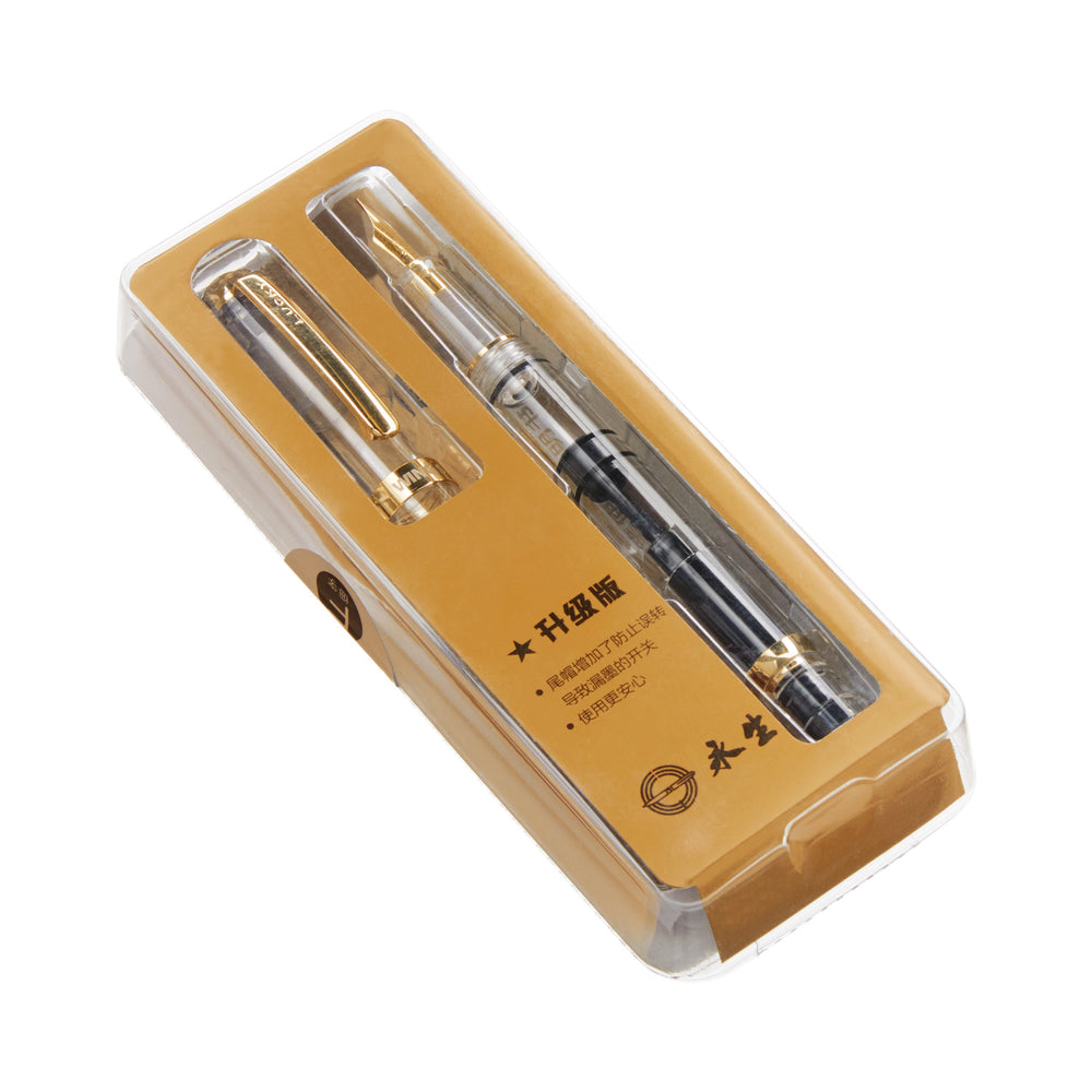 Wing Sung 698 (Clear/Gold) - Fine fountain pen in retail blister pack, showcasing its clear body, gold-tone trim, matching cap, and Chinese-branded insert card.