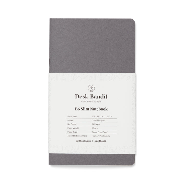 Tomoe River Notebook - B6 Slim (Dot Grid), graphite-grey, softcover, 107×182 mm, wrapped in paper band, featuring 64 pages of fountain-pen friendly, 68 gsm paper.