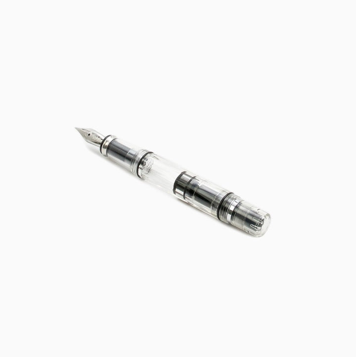 Diamond Mini (Clear) - Broad: Transparent fountain pen by TWSBI, showcasing a piston filler mechanism, metal nib, and compact design for portability.