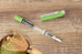 TWSBI ECO fountain pen in Matcha colourway, resting on a wooden table with a matcha bowl and bamboo whisk