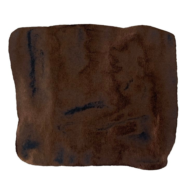 Swatch of Taccia Black (Jeans) ink, featuring uneven brown patches on white, reflecting a brushed, watercolor texture. Inspired by denim jeans.