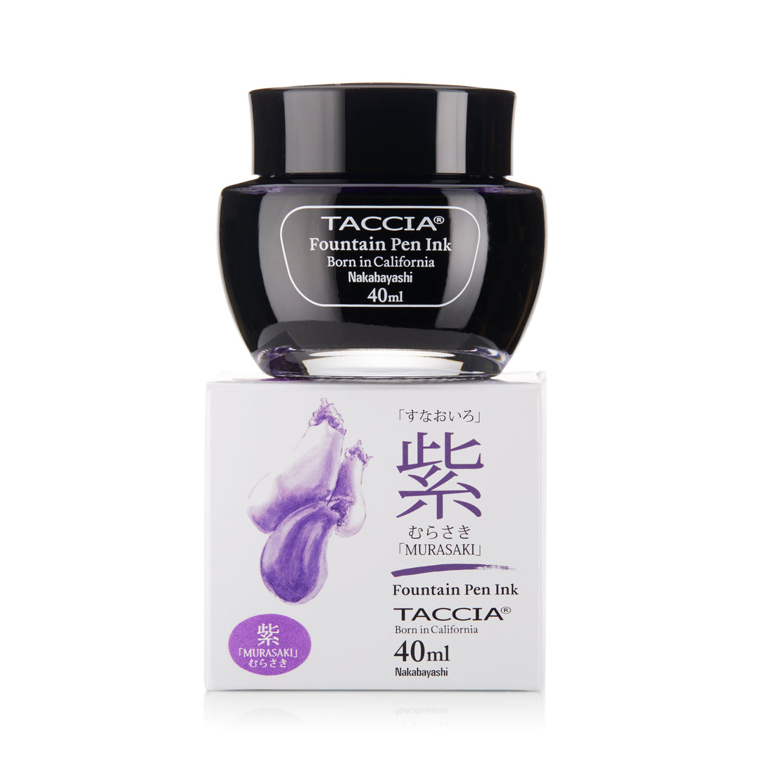 Glass jar of TACcia Murasaki - 2ml fountain pen ink on its matching white box, labeled with English and Japanese text, emphasizing its Japanese-inspired color purity.