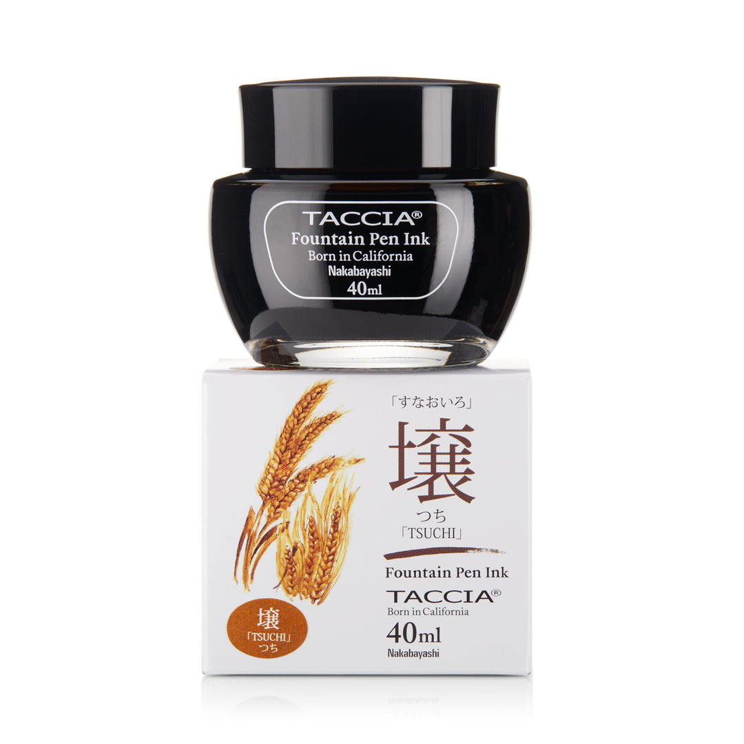 Tsuchi - 2ml sample of TACCiA fountain-pen ink in a 40 ml glass jar, displayed on its box featuring a wheat illustration and Japanese text.