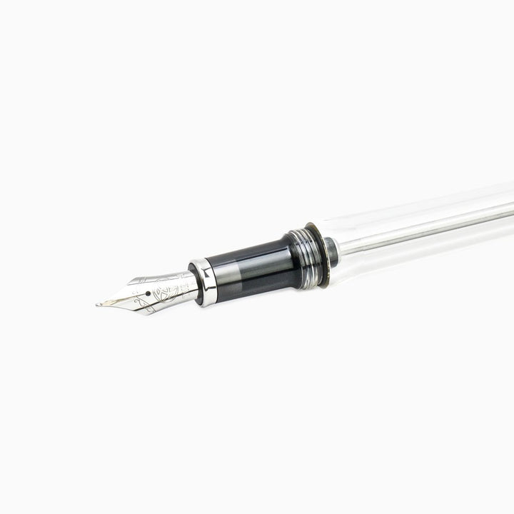 VAC 700R (Clear) - Broad fountain pen showcasing its metal nib, black grip, and transparent barrel, highlighting the vacuum system and large ink reservoir.