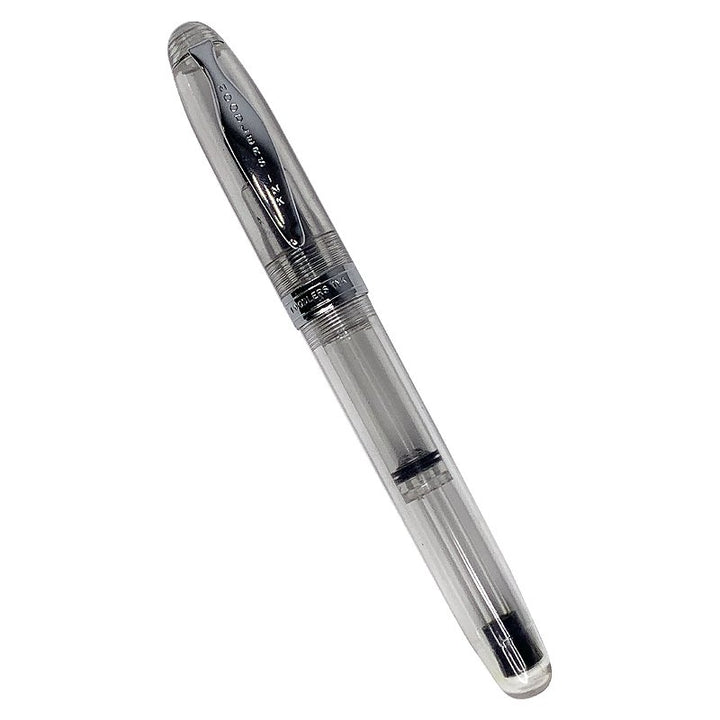 Ahab Flex - Clear Demonstrator: Transparent fountain pen with clear acrylic barrel, metal cap, and flexible steel nib, showing piston-filling mechanism inside.