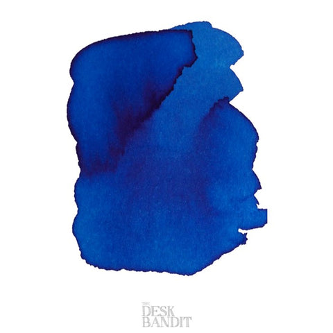 Iroshizuku Ink - Ama-Iro (2ml) sample; deep blue swatch with irregular edges on white background, subtle darker gradient, watermark The Desk Bandit visible.