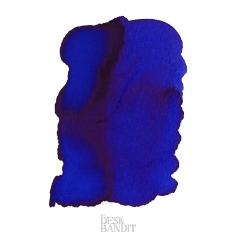 Close-up of Iroshizuku Ink - Asa-Gao (2ml) sample, showcasing a vibrant blue swatch with subtle shading and pooling, labeled with The Desk Bandit watermark.
