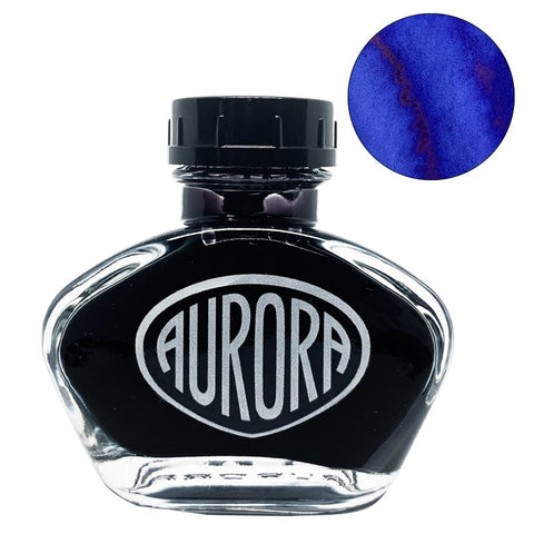 Aurora 100th Anniversary - Blue (55ml) ink bottle with clear glass body, black cap, silver logo, and a deep blue swatch with a reddish sheen.