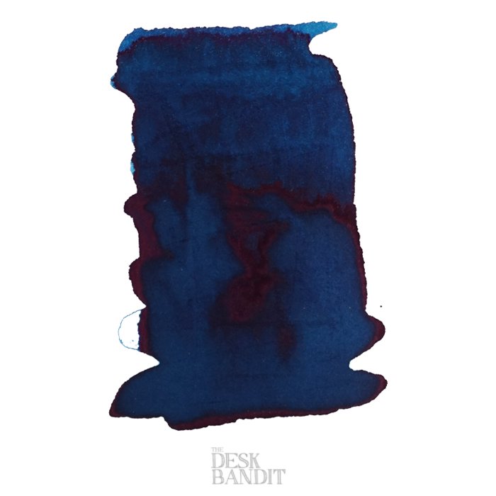 Blue Denim - 2ml ink sample swatch, showing deep blue with red sheen edges and THE DESK BANDIT watermark on a white background.