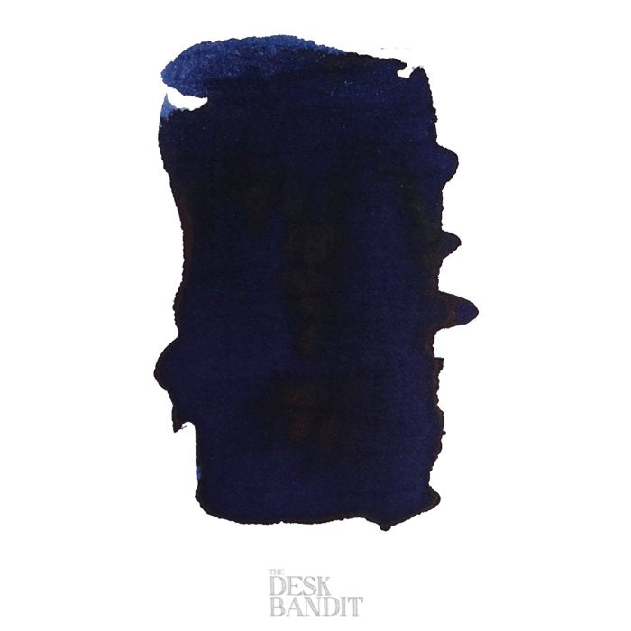 Swatch of Robert Oster's Blue Night ink, 2ml sample, displayed as a dark navy watercolor stroke on white, with The Desk Bandit watermark below.