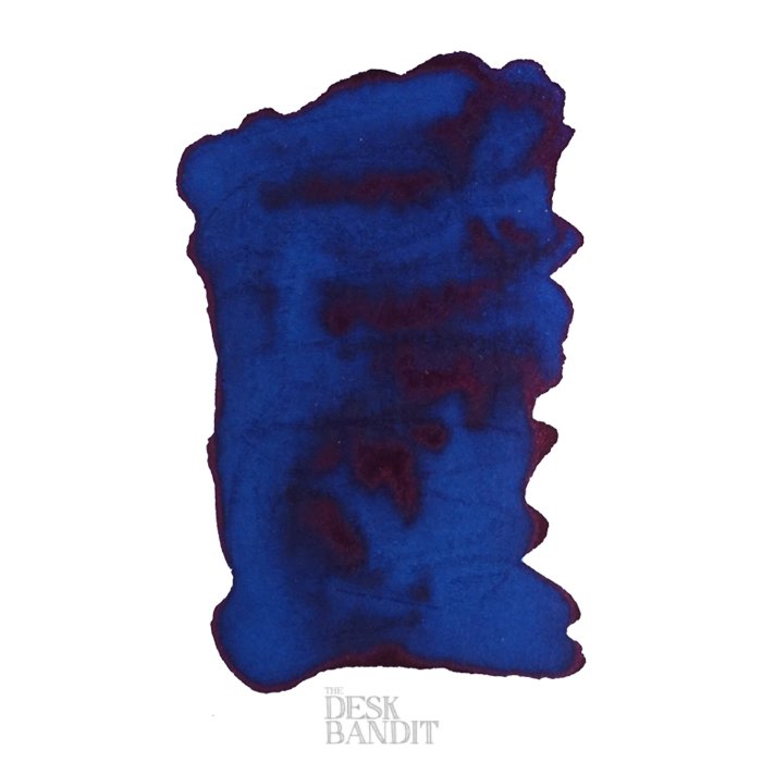 Blue Sea - 2ml ink sample by Robert Oster, showing deep blue with reddish-purple sheen on white paper, featuring The Desk Bandit watermark.