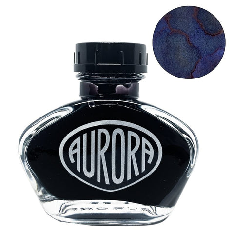 Aurora 100th Anniversary - Blue Black (55ml) fountain-pen ink in a glass bottle, features deep blue ink with a red sheen in a round swatch inset.