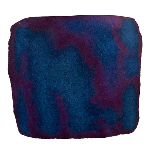 Blue Black - 2ml ink sample showing a deep teal-blue center fading into purplish-magenta edges, illustrating Colorverse's plant-based, smooth-writing dye-based ink.