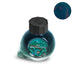 2025 Blue Green Snake - 15ml glass ink bottle with faceted black cap, teal-blue/green ink, and a deep, sheening teal ink swatch inset.