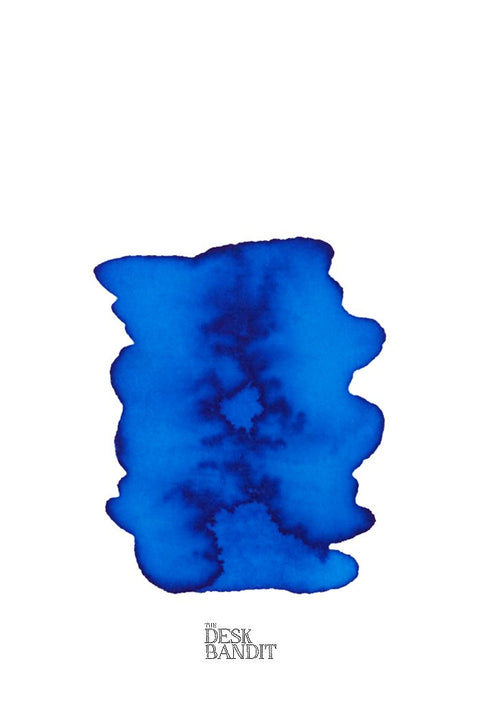 Blu Mare (2ml) ink swatch with organic edges and darker veining on a sample card branded “THE DESK BANDIT,” showcasing Rohrer & Klingner's handcrafted quality.