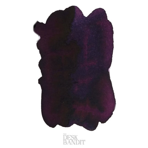 Claret - 2ml: A deep purple-black fountain pen ink sample with red/purple sheen, displayed on white paper, featuring the Desk Bandit watermark.