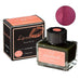 20 ml Taccia Lip Color Ink in Coral Pink, with outer carton. Includes a swatch displaying the ink's coral-pink hue when applied.