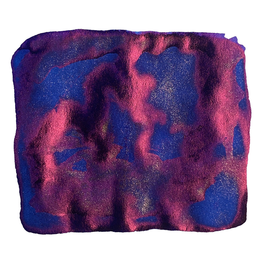 Cosmic Blue (Kosmos 1955) ink swatch displays a marbled interplay of blue, magenta, and fuchsia with gold flecks, evoking a starry Philippine sky.